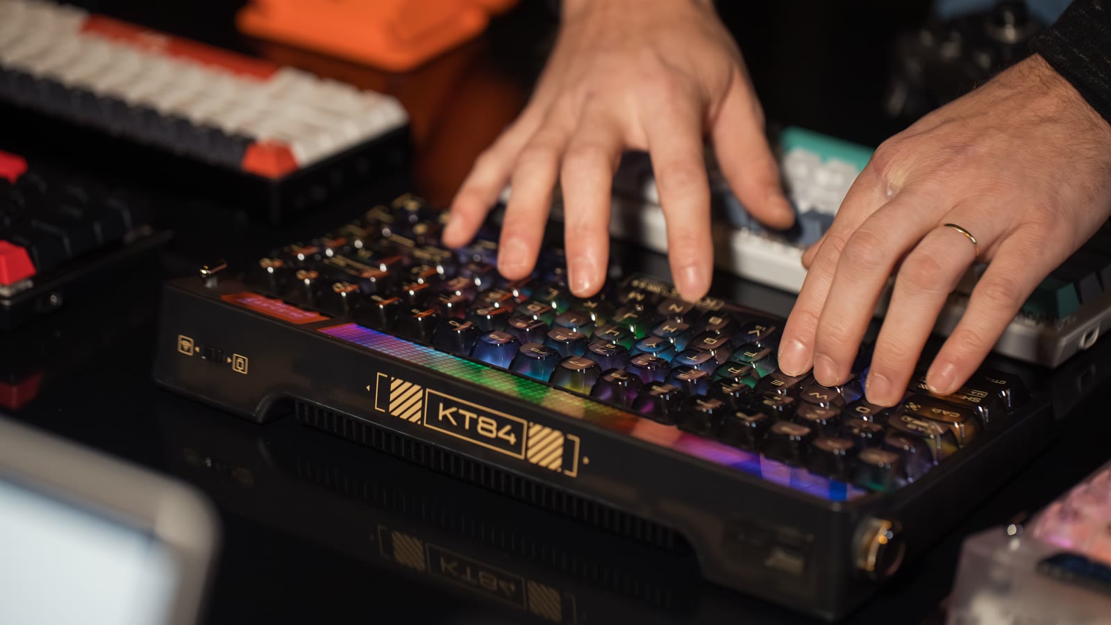 Hænder skriver på et mekanisk tastatur med RGB-belysning